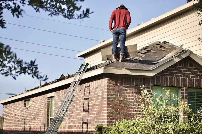 Professional roofer working on a residential roof in Wolf Trap